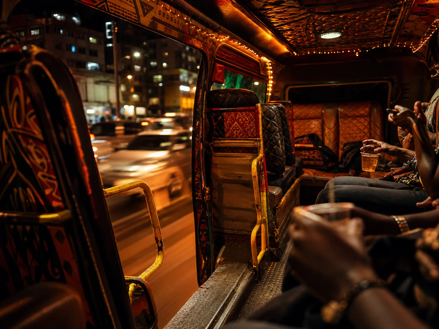 Warm Nairobi nganya interior with city lights in motion